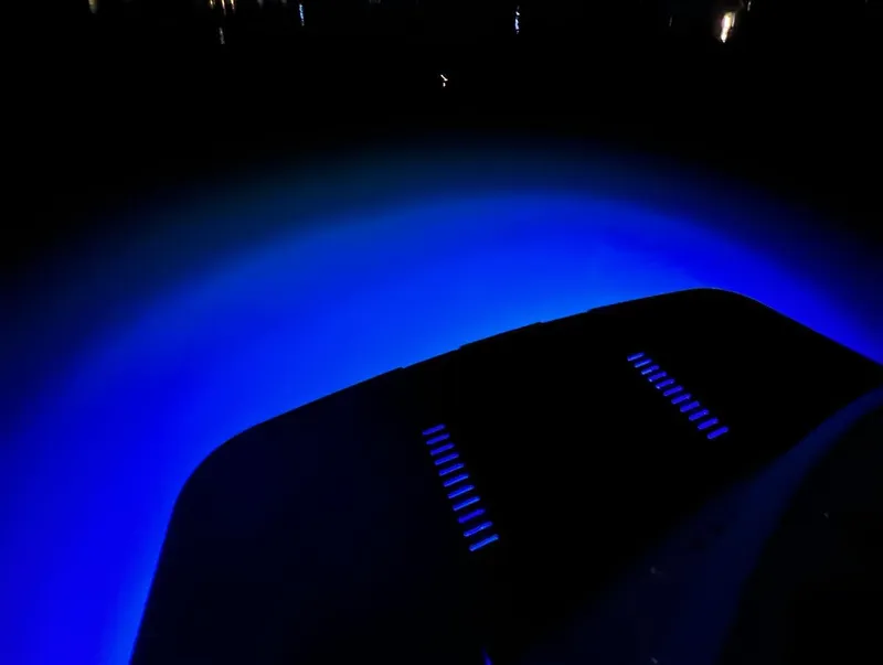 Slide: The Image of 2018 Princess V58 yacht docked at night with glowing green underwater lights. - 11