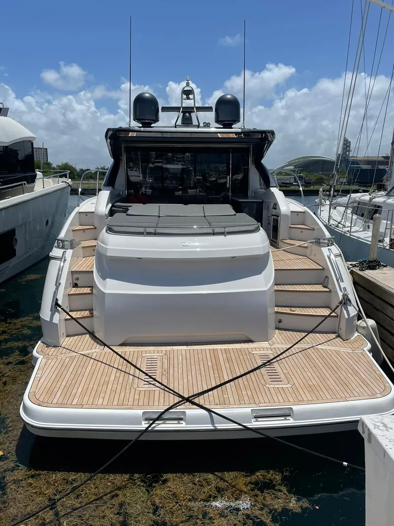 Slide: The Image of 2018 Princess V58 yacht docked at marina, showcasing sleek design and luxury features. - 19