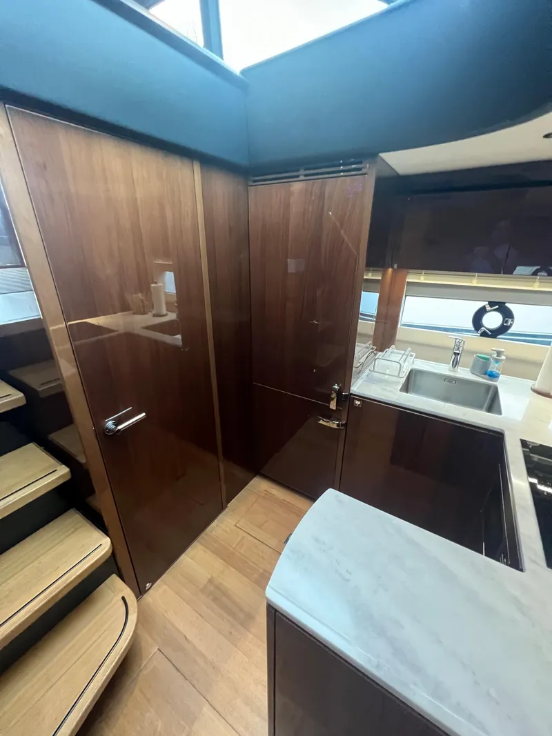 Slide: The Image of Luxurious 2018 Princess V58 yacht kitchen with modern appliances and wooden cabinetry. - 43