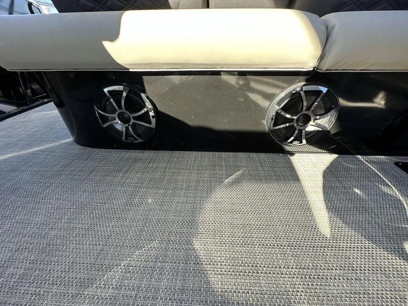 Slide: The Image of 2023 Silver Wave 2410 SW7 JS boat interior with speakers and cushioned seating. - 11