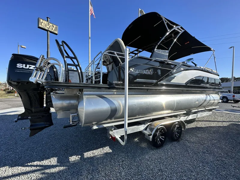 Slide: The Image of 2023 Silver Wave 2410 SW7 JS pontoon boat with Suzuki engine, parked on gravel. - 3