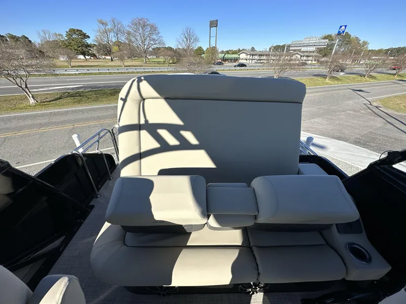 Slide: The Image of 2023 Silver Wave 2410 SW7 JS boat with beige seating, parked near a road. - 4