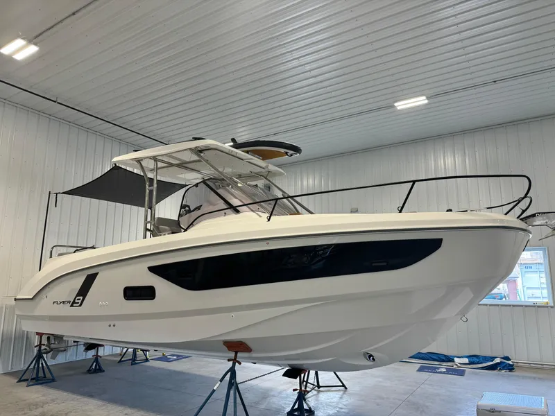Slide: The Image of 2023 Beneteau Flyer 9 SUNdeck boat in indoor storage on stands. - 1