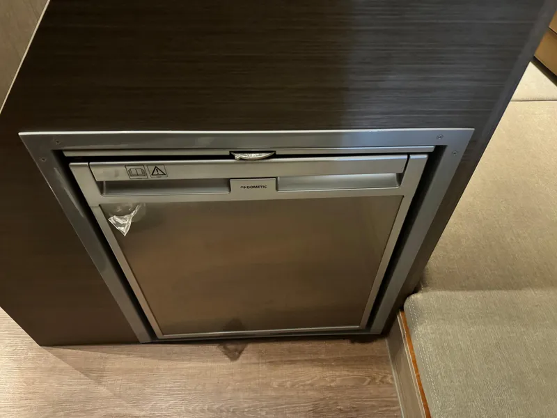 Slide: The Image of Built-in refrigerator on the 2023 Beneteau Flyer 9 SUNdeck boat. - 17