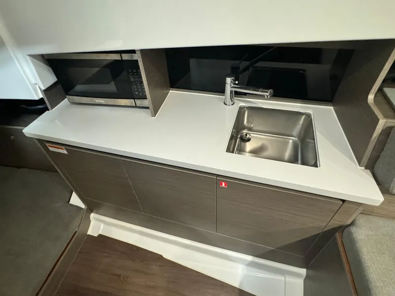 Slide: The Image of 2023 Beneteau Flyer 9 SUNdeck kitchen area with sink and microwave. - 18