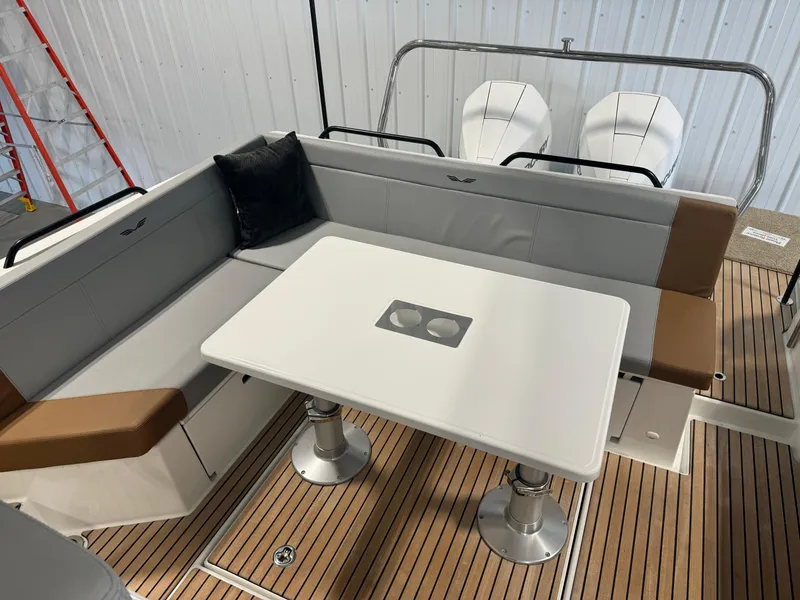 Slide: The Image of 2023 Beneteau Flyer 9 SUNdeck interior seating area with table and twin engines. - 9