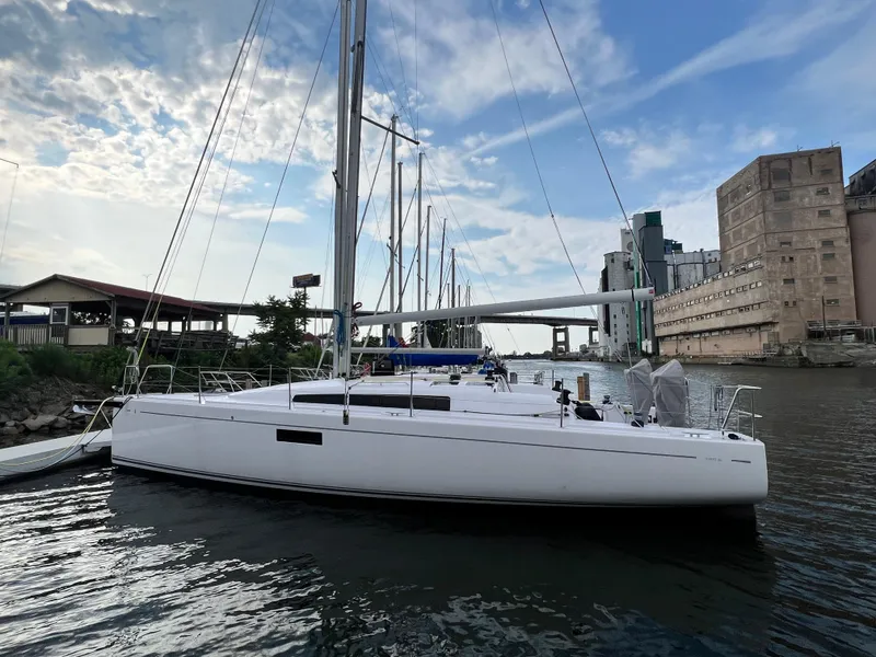 Slide: The Image of 2023 Beneteau First 36 sailboat docked at a marina. - 1