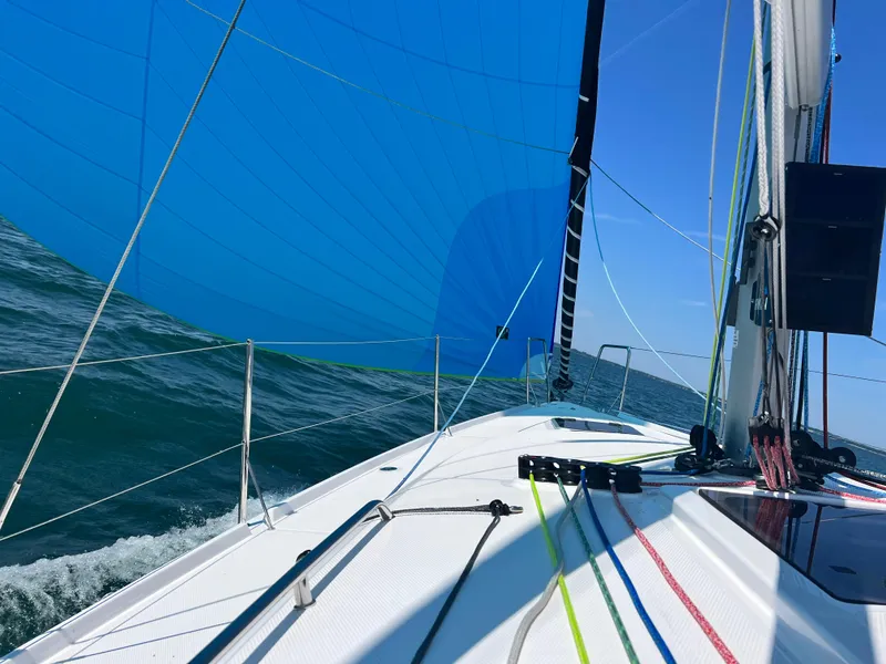 Slide: The Image of 2023 Beneteau First 36 sailing on open water with blue spinnaker. - 13