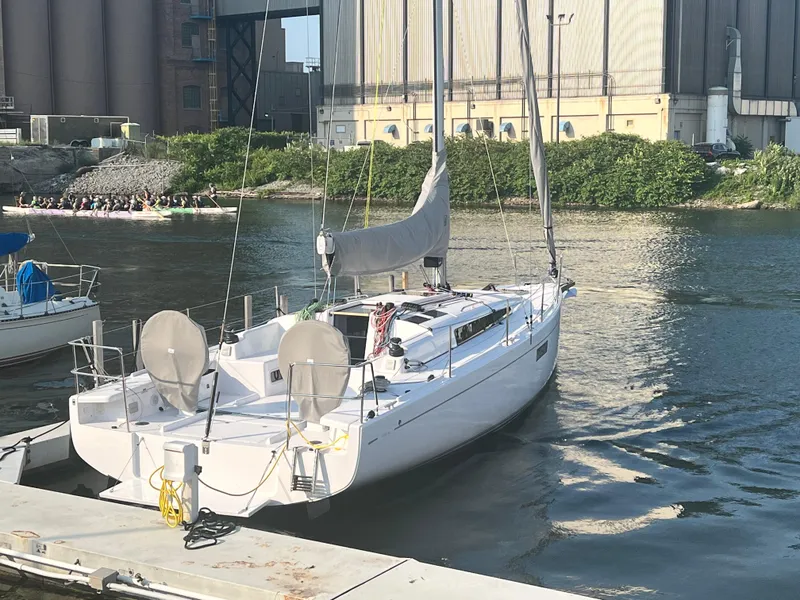 Slide: The Image of 2023 Beneteau First 36 sailboat docked at a marina. - 16
