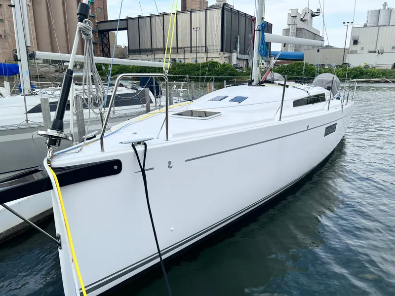 Slide: The Image of 2023 Beneteau First 36 sailboat docked in a marina. - 2