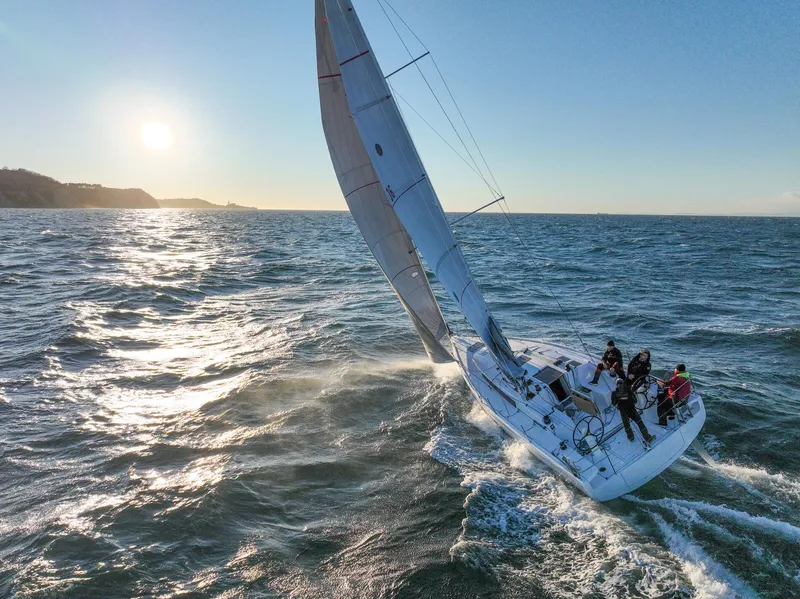 Slide: The Image of 2023 Beneteau First 36 sailing on open sea at sunset. - 21