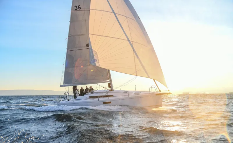 Slide: The Image of 2023 Beneteau First 36 sailboat navigating ocean at sunset. - 22