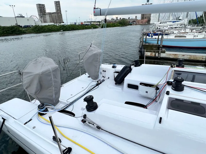 Slide: The Image of 2023 Beneteau First 36 sailboat docked at a marina, showcasing its deck and rigging. - 3