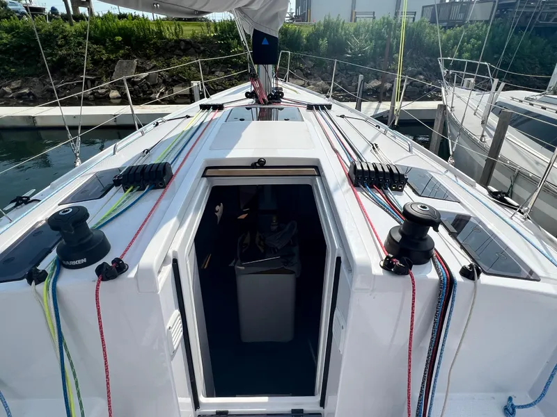 Slide: The Image of 2023 Beneteau First 36 sailboat deck with colorful rigging at marina. - 4