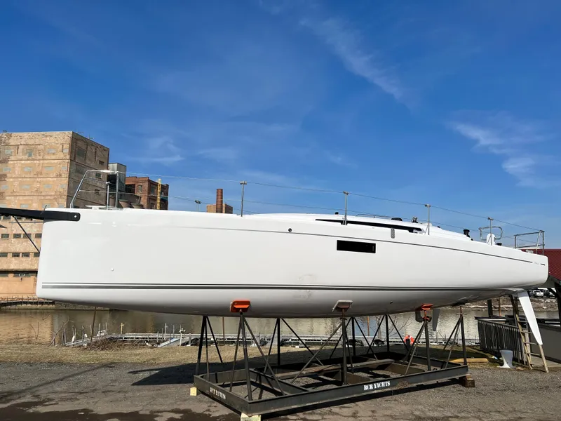 Slide: The Image of 2023 Beneteau First 36 sailboat on display, set against an industrial backdrop. - 42