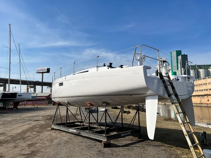 Slide: The Image of 2023 Beneteau First 36 sailboat on dry dock under clear blue sky. - 43
