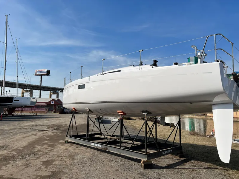 Slide: The Image of 2023 Beneteau First 36 sailboat on dry dock under clear blue sky. - 44