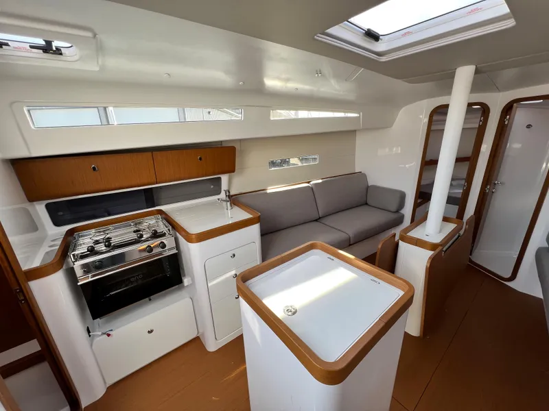 Slide: The Image of 2023 Beneteau First 36 yacht interior with modern kitchen and seating area. - 46