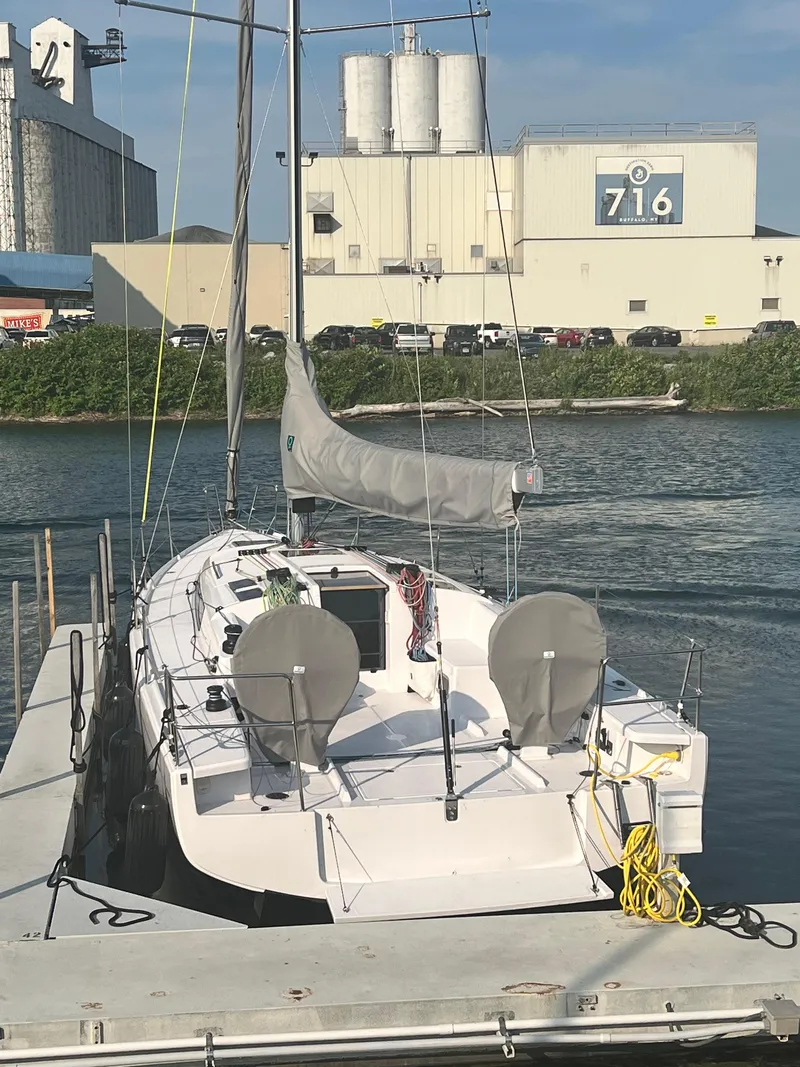 Slide: The Image of 2023 Beneteau First 36 sailboat docked at an industrial marina. - 5