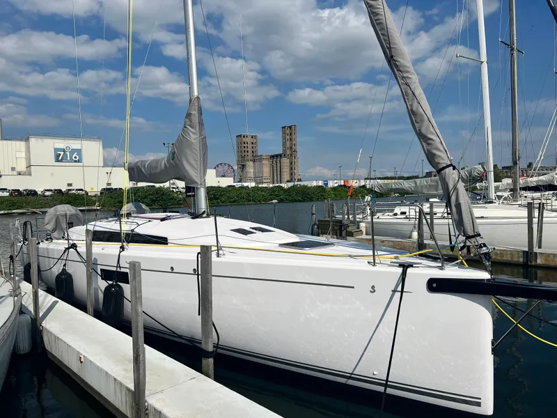 Slide: The Image of 2023 Beneteau First 36 sailboat docked at a marina. - 7