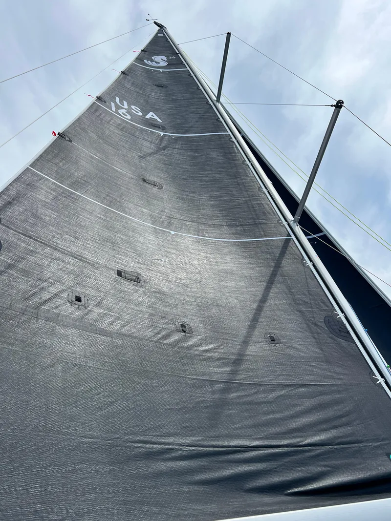 Slide: The Image of 2023 Beneteau First 36 sailboat mast and sail against a cloudy sky. - 9
