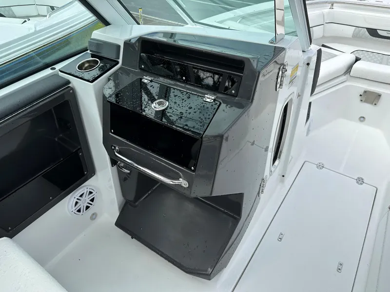 Slide: The Image of 2023 Blackfin 252 DC boat interior with helm station and storage compartments. - 11
