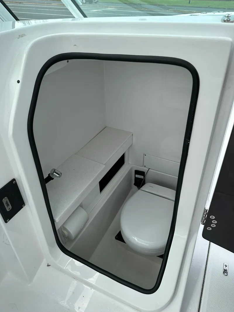 Slide: The Image of 2023 Blackfin 252 DC boat interior bathroom with toilet and storage. - 12