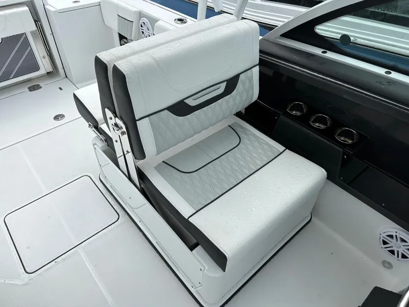 Slide: The Image of 2023 Blackfin 252 DC boat interior with white cushioned seating. - 13