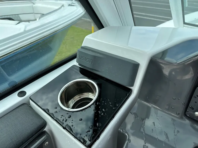 Slide: The Image of 2023 Blackfin 252 DC boat interior with cup holder and storage compartment. - 14