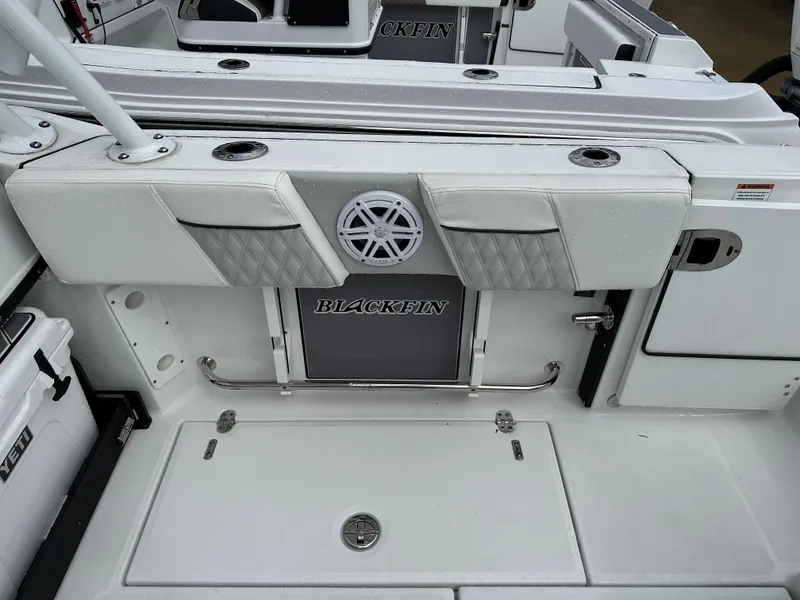 Slide: The Image of 2023 Blackfin 252 DC boat interior with storage compartments and seating. - 16