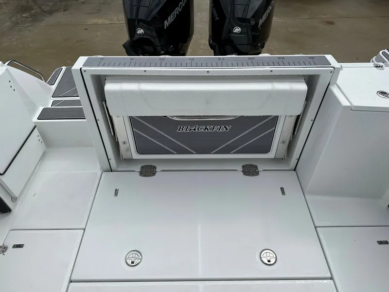 Slide: The Image of 2023 Blackfin 252 DC boat deck with Mercury engines in the background. - 17