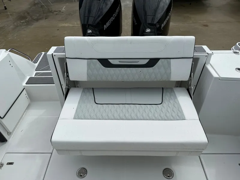 Slide: The Image of 2023 Blackfin 252 DC boat with white cushioned seating and dual Mercury outboard engines. - 19