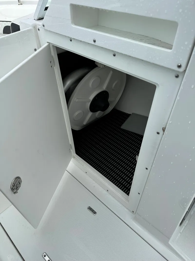 Slide: The Image of Open storage compartment on a 2023 Blackfin 252 DC boat. - 6