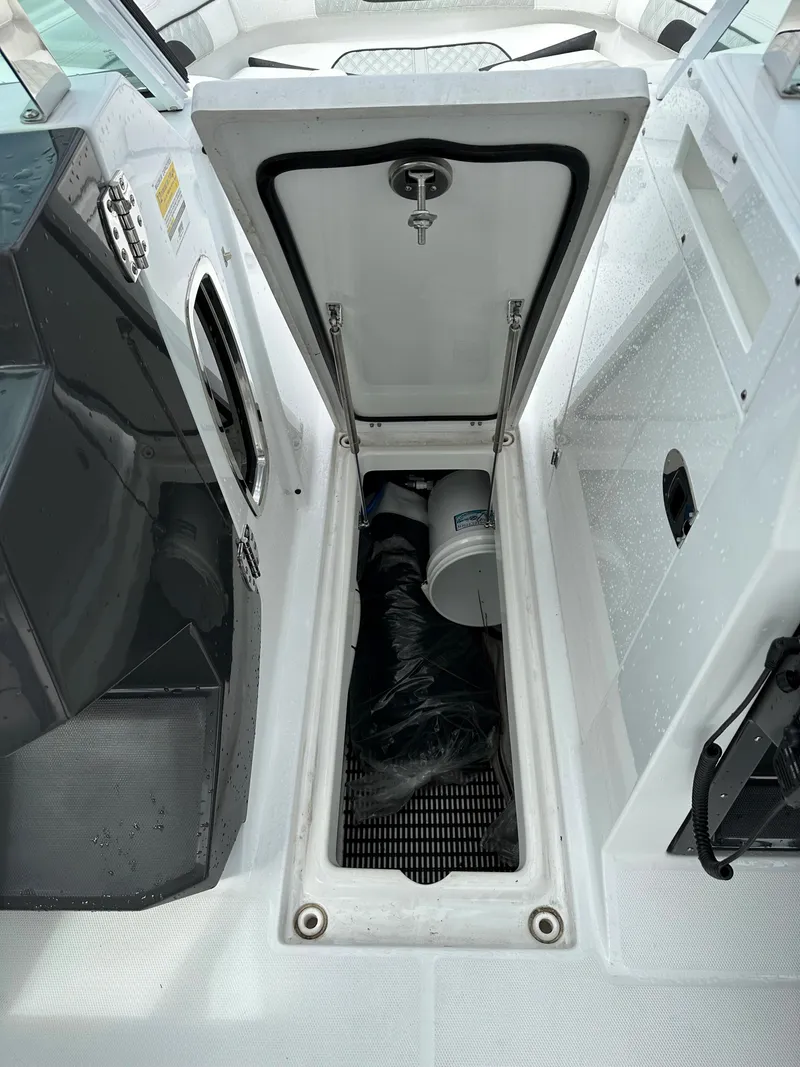 Slide: The Image of 2023 Blackfin 252 DC storage compartment with open hatch. - 7