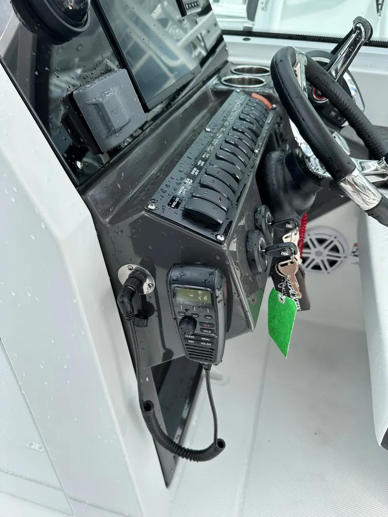 Slide: The Image of Control panel of 2023 Blackfin 252 DC boat with steering wheel and radio. - 9
