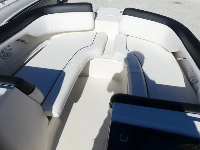 Slide: The Image of 2018 Bayliner 210 Deck Boat interior with white seating and black trim. - 11