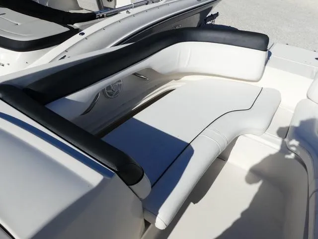 Slide: The Image of 2018 Bayliner 210 Deck Boat interior seating with white and black upholstery. - 12