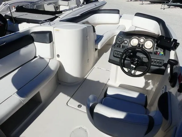 Slide: The Image of 2018 Bayliner 210 Deck Boat interior with steering console and seating. - 7