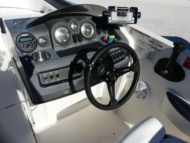 Slide: The Image of 2018 Bayliner 210 Deck Boat dashboard with steering wheel and control panel. - 8