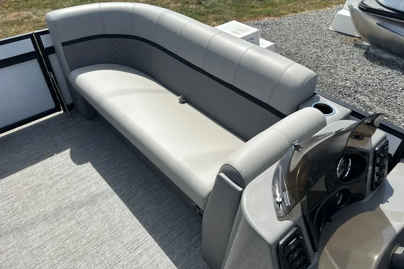 Slide: The Image of 2023 Qwest E-Class 820 Lanai LT boat interior with gray seating and control panel. - 10