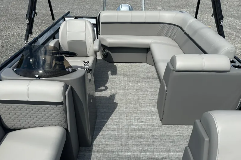 Slide: The Image of 2023 Qwest E-Class 820 Lanai LT pontoon boat interior with gray seating and helm. - 11