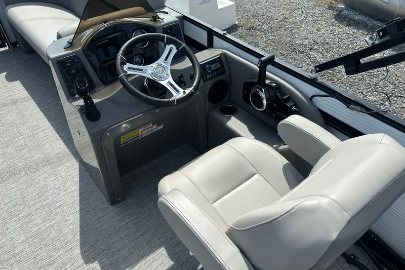 Slide: The Image of 2023 Qwest E-Class 820 Lanai LT boat interior with steering wheel and captain's chair. - 13