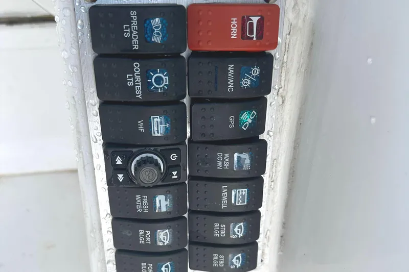 Slide: The Image of Control panel of a 2006 Glacier Bay 2240 Dual Console boat with various switches. - 12