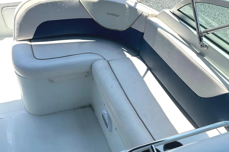 Slide: The Image of 2006 Glacier Bay 2240 Dual Console boat interior with cushioned seating and windshield. - 17