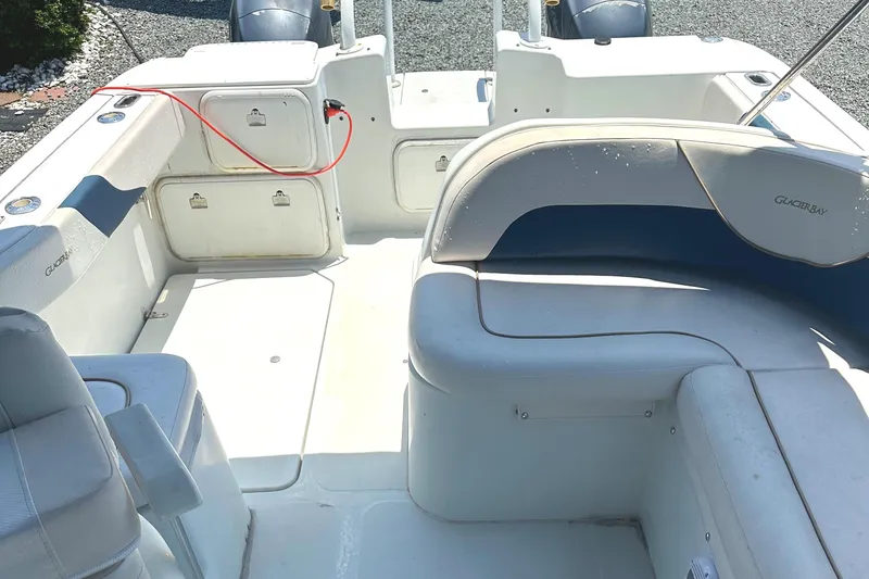 Slide: The Image of 2006 Glacier Bay 2240 Dual Console boat interior with seating and storage compartments. - 18