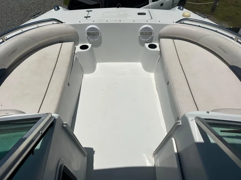 Slide: The Image of 2006 Glacier Bay 2240 Dual Console boat interior with cushioned seating and cup holders. - 2