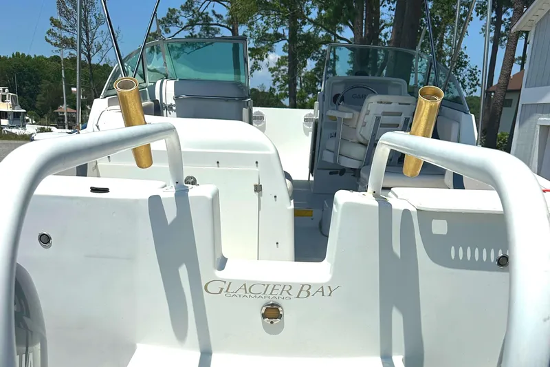 Slide: The Image of 2006 Glacier Bay 2240 Dual Console boat interior with rod holders and seating. - 4