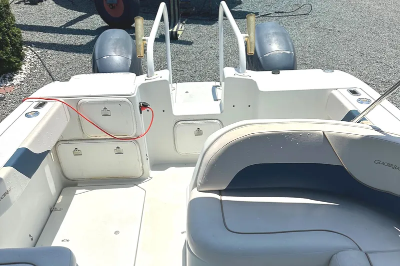 Slide: The Image of 2006 Glacier Bay 2240 Dual Console boat interior with seating and storage compartments. - 7