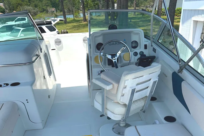 Slide: The Image of 2006 Glacier Bay 2240 Dual Console boat interior with steering wheel and seating. - 8