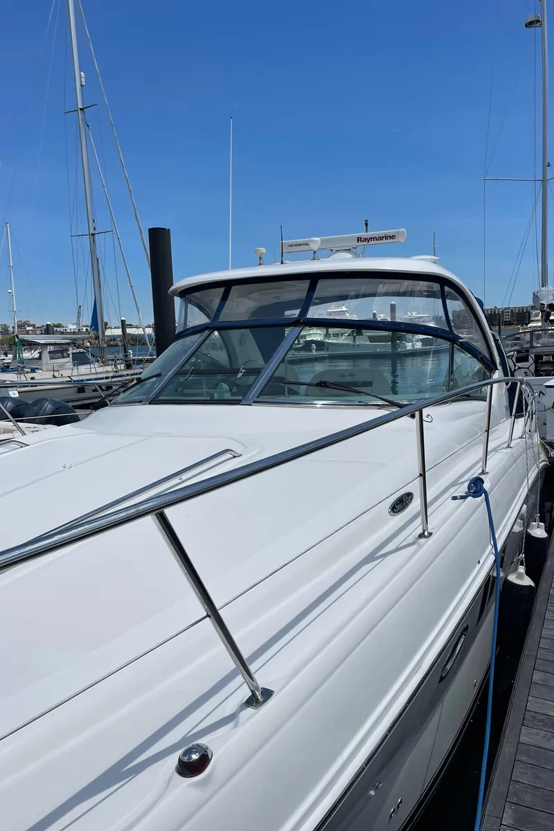 Slide: The Image of 2011 Sea Ray 390 Sundancer yacht docked at marina under clear blue sky. - 10